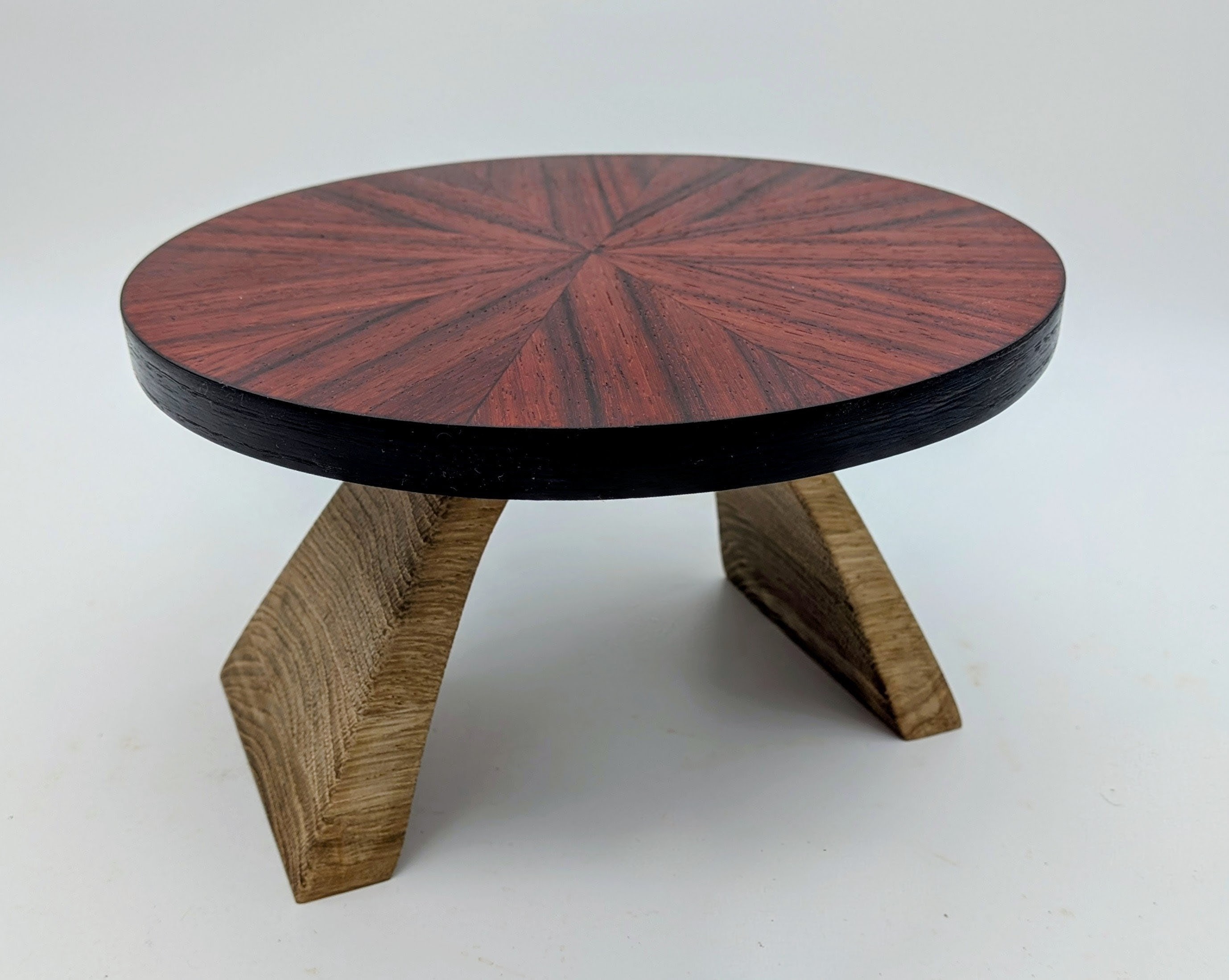 Scale model coffee table with sunburst veneer and arched white oak base.