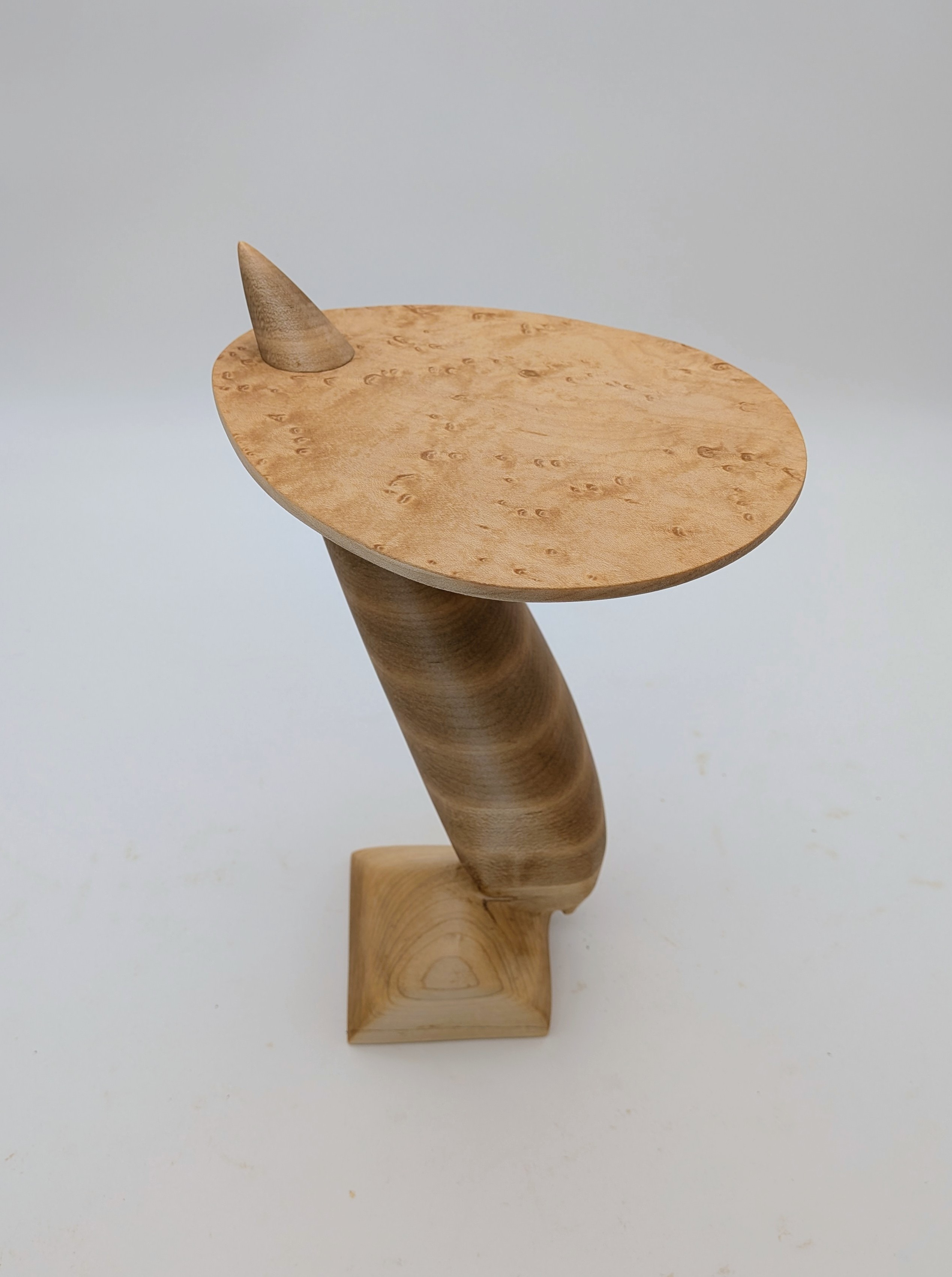 Carved maple side table with cantilevered tabletop
