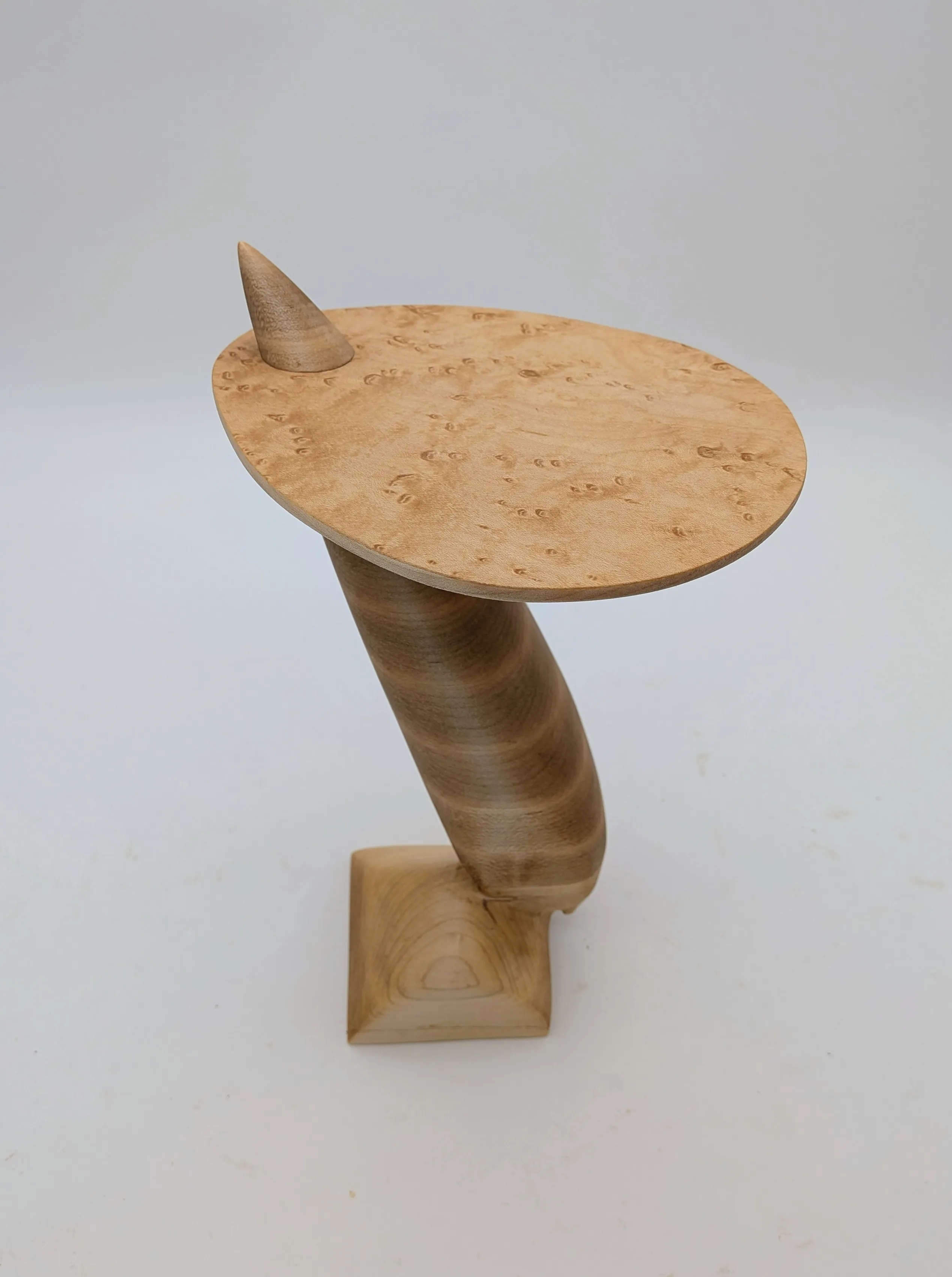 Carved maple side table with cantilevered tabletop